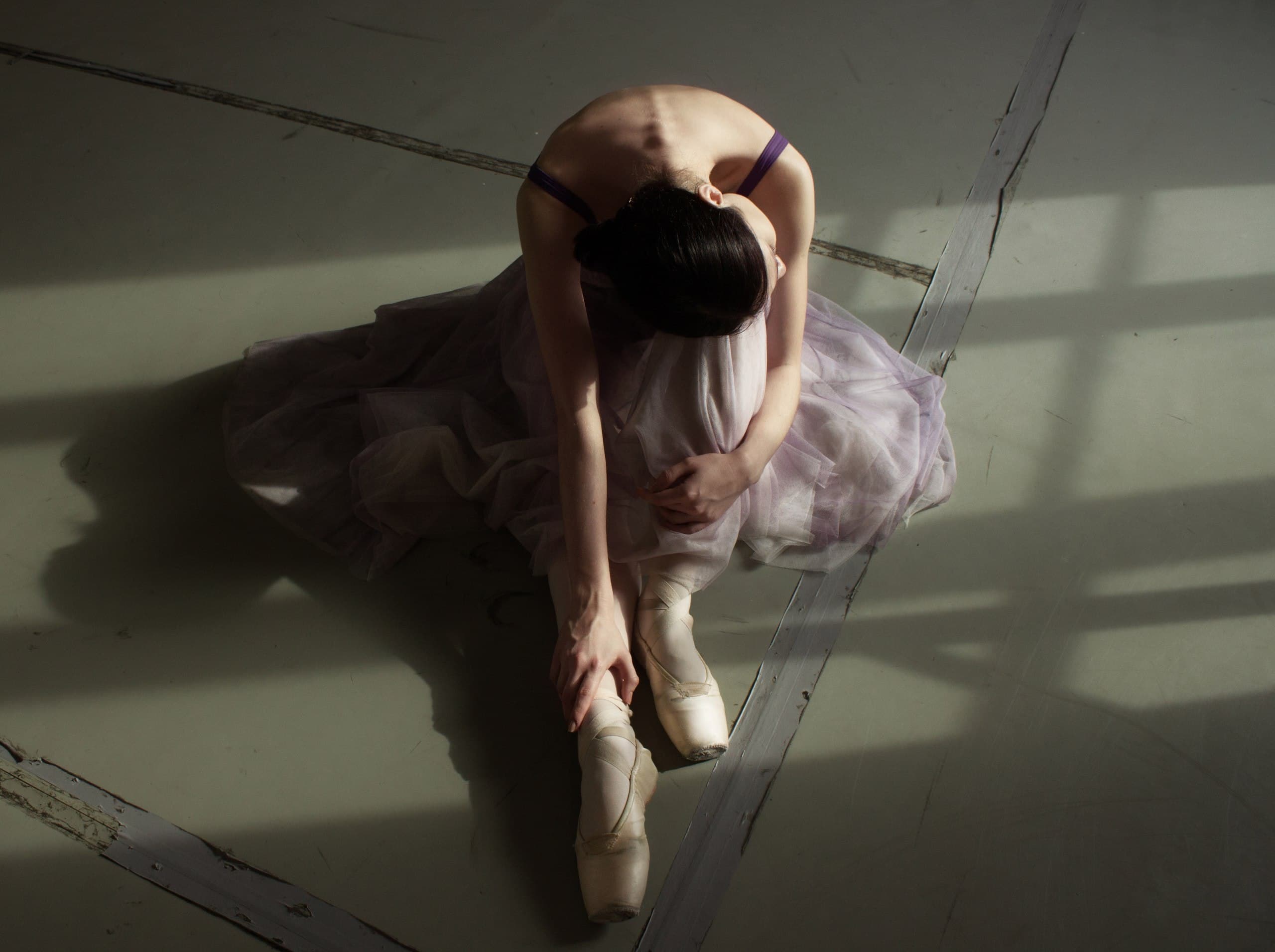 Ballerina preparing pointe shoes